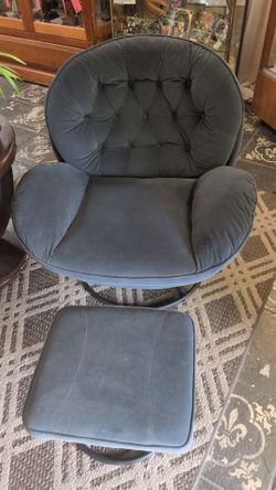 Adorable bluish gray swivel chair with matching ottoman.