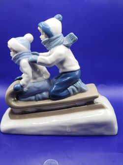 Children Sledding Porcelain Figurine