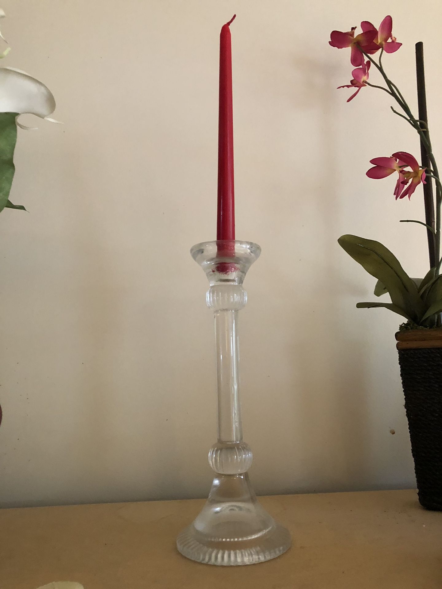 2 candle holders with one maroon candle