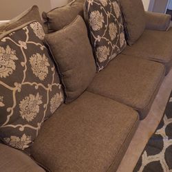 Grey couch with 4 matching pillows