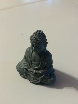 small dark gray meditating Buddha figurine features finely textured robe folds for a calm zen accent.