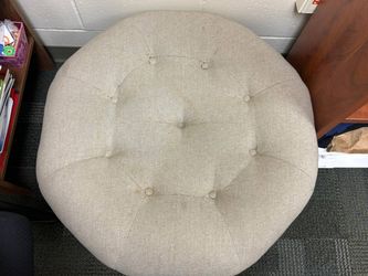 A large round, button-tufted cocktail ottoman - Monterey