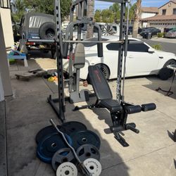 Smith machine with 230lbs of Olympic weights and curl bar