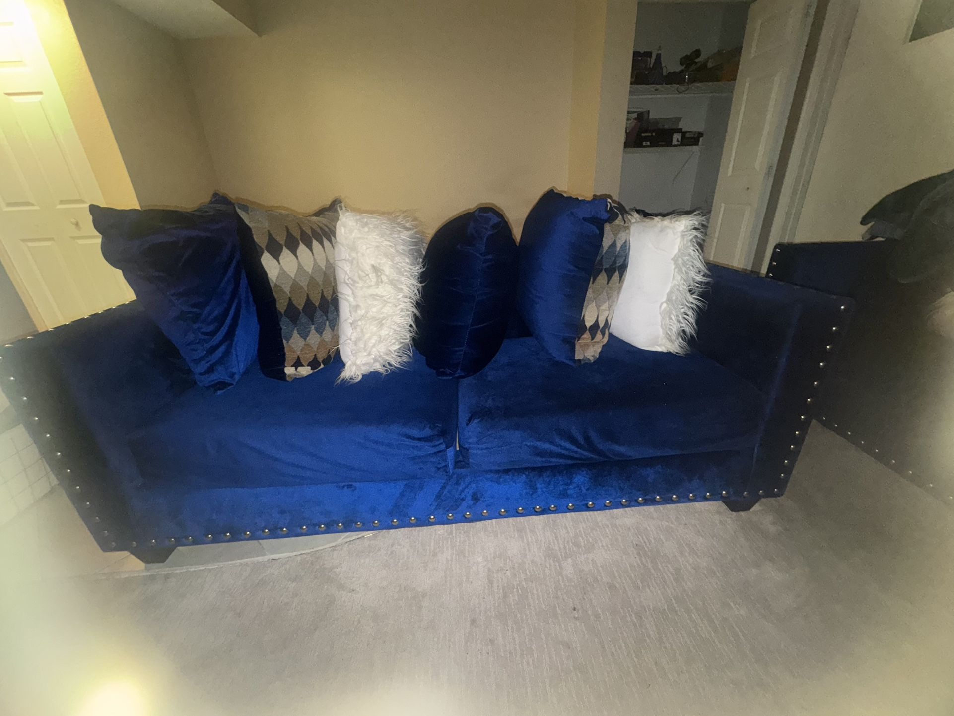 Two Blue Silk Couches With White Furry Pillows And Blue Silk Pillows 