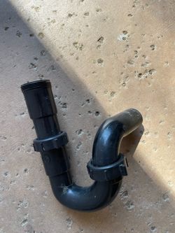 Black plastic P-trap sink drain pipe