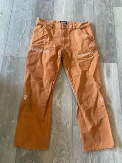 Felt orange trousers with white flower embroidery. Size: XL #embroidery #floral