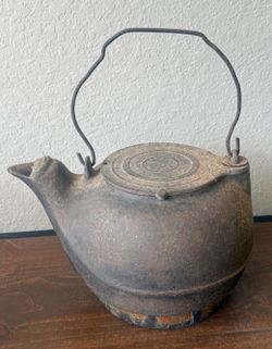 Antique Cast Iron Teapot with a Spherical Body and Handle