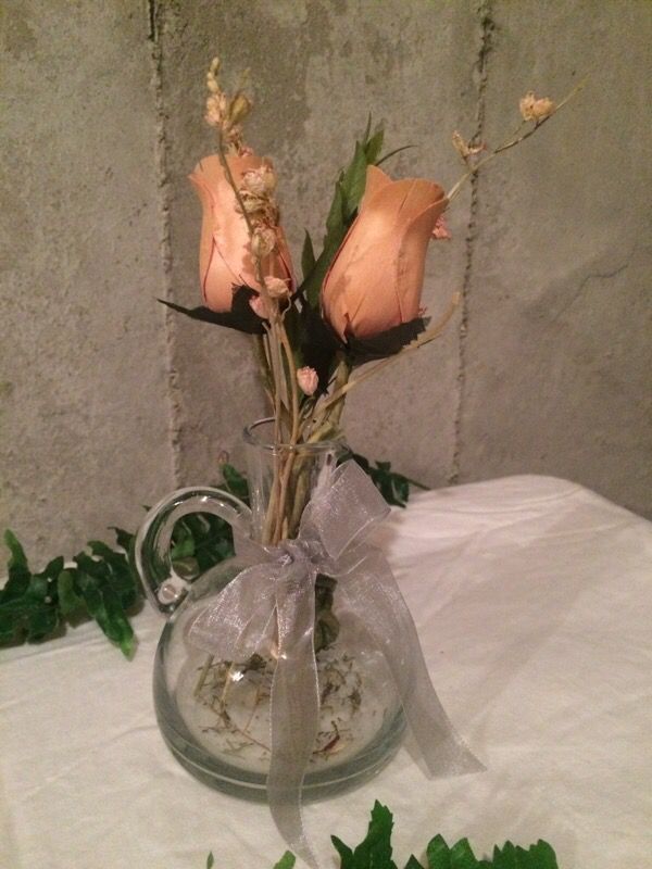 Silk flowers in Glass Handled Vase