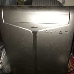 Sharp AC unit, tube is stucked to window to let hot air go out.