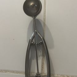 stainless steel spring-action scoop, also known as a disher, used for portioning foods like ice cream, cookie dough, or melon balls.  Material: Constr