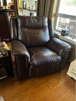 Ashley Furniture Dark  Brown, leather power recliner, power headrest also a rocker and USB connector