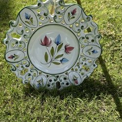 This is a vintage, hand-painted ceramic plate from Portugal, likely from the brand "REEL".  It