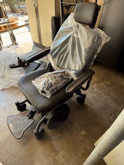 Pride Jazzy EVO 613 / 613Li motorized power wheelchair in black vinyl upholstery,