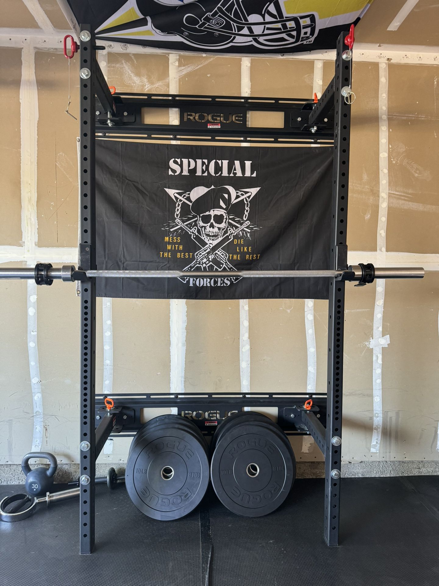 Rogue half rack with weights.