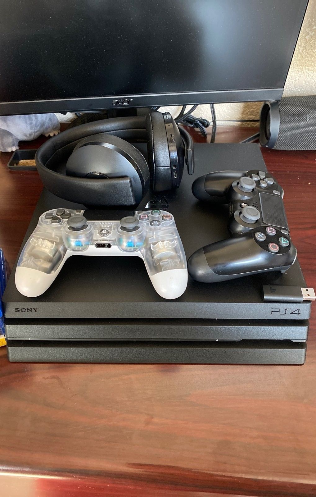 PS4 pro with double controllers and a headset.