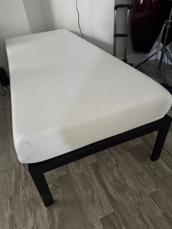 Narrow twin metal bed frame with mattress