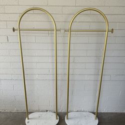 modern gold metal freestanding coat rack with a marble base