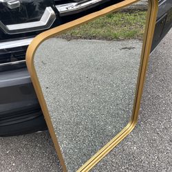 Mirror with gold trim.  24”X36”