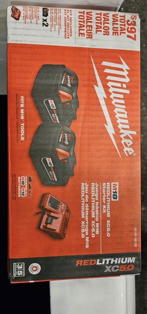 Two Milwaukee M18 5.0 Batteries And Charger