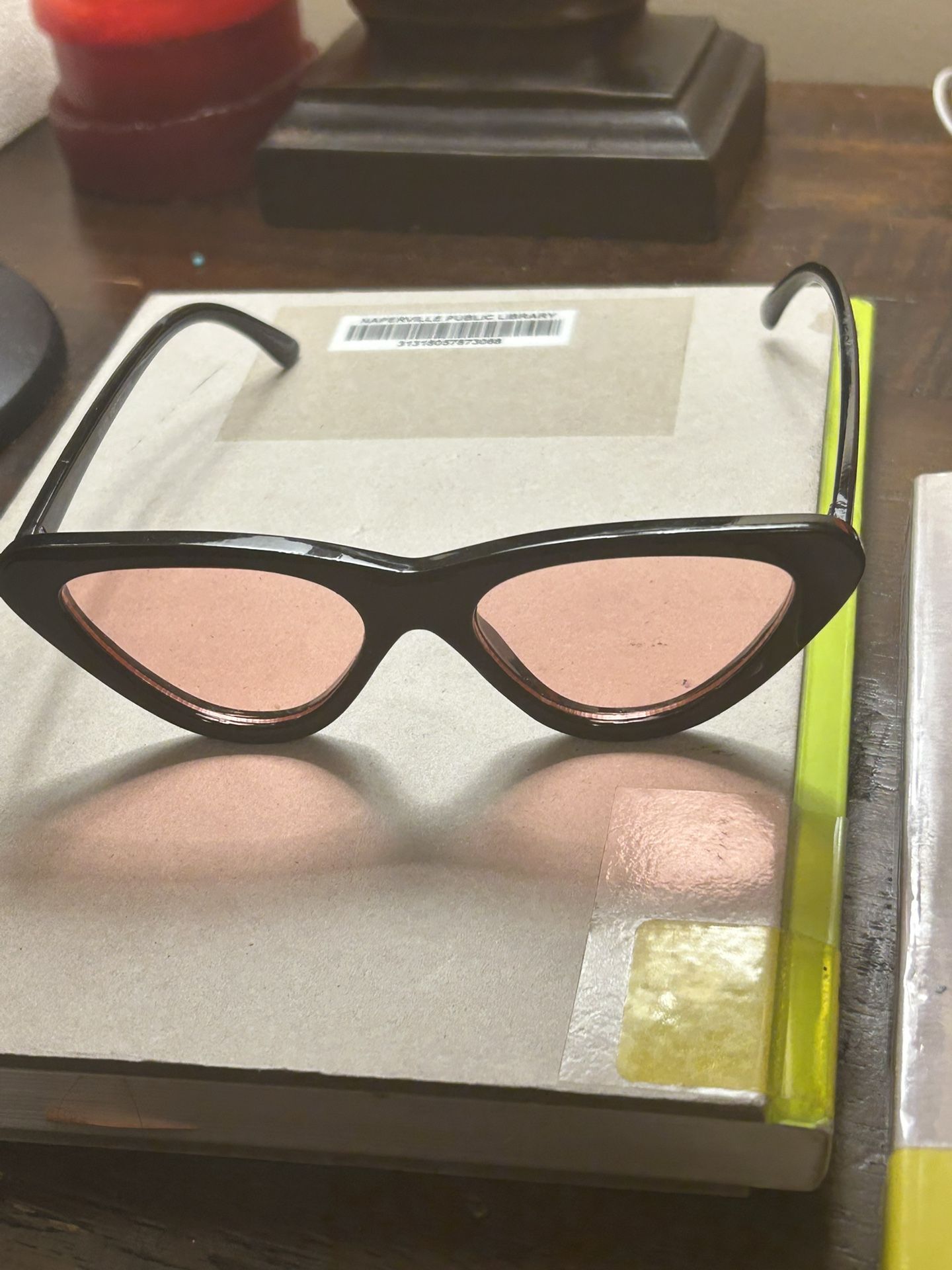 cat-eye sunglasses with a black frame and pink lense