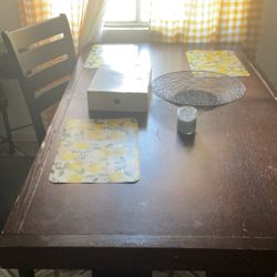 Kitchen table with two chairs and a bench