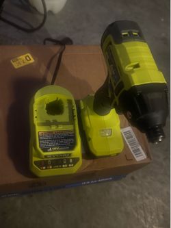 Ryobi impact drill with battery and charger.
