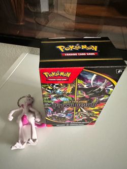 Pokemon cards, rug, and Mewtwo chain
