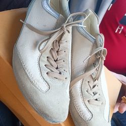 This is a pair of Tod's men's sneakers in cream/tan suede and leather. 