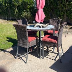 Table, Chairs And Umbrella. 