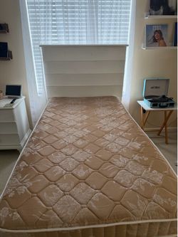 White twin bed with mattress and boxspring
