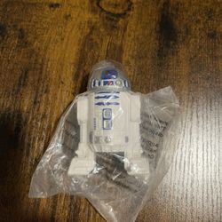 R2-D2 action figure, likely from the Star Wars franchise