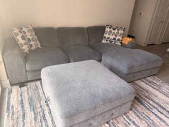 Selling our Rooms To Go Marcola Ash 2-Piece Sectional with matching Storage Ottoman. It is in excellent pre-owned condition and has been very well car