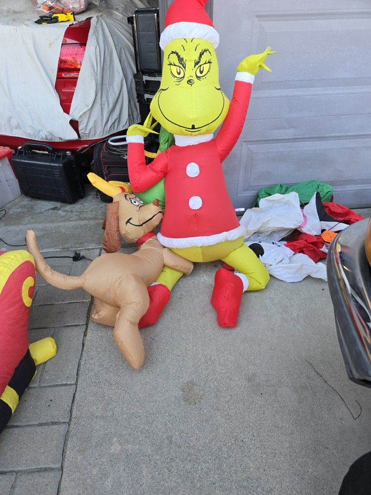 7 Ft Tall Grinch Hanging With Dog On Leg Inflatable