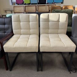 Modern Dining Chairs – Set of 2  Beautiful modern dining chairs in cream color. Soft cushioned seat and back with stylish square stitching. Sturdy bla