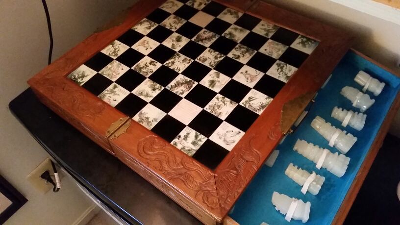 Antique chess board with handcarved pieces
