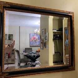 Mirror with black and gold trim