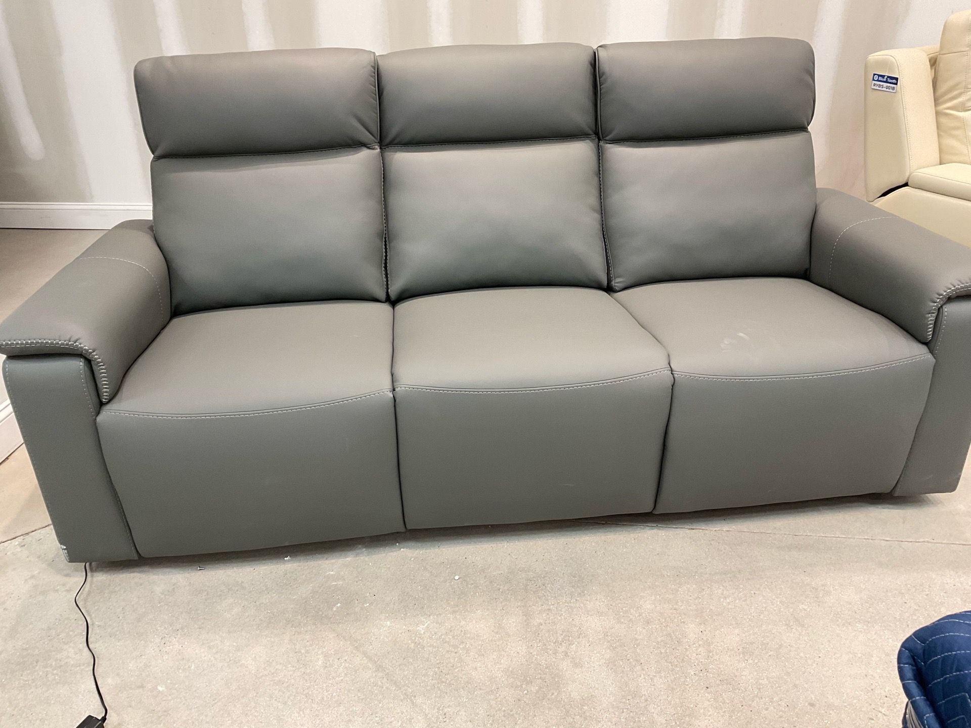 New Dual Power reclining Sofa gray leather by Nisco.