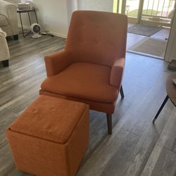 orange chair and footstool with storage compartment