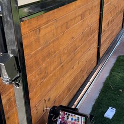 Sliding gate with black metal frame and cedar wood