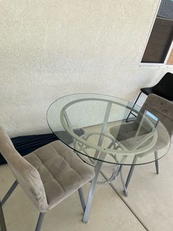 Round Glass Top Table with 2 small comfy chairs