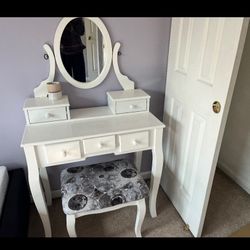 Makeup vanity with mirror and chair 