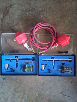 For sale: Two complete airbrush kits in their original cases .