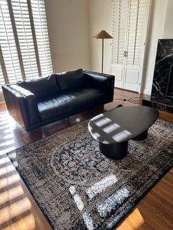 Black sofa, carpet, table