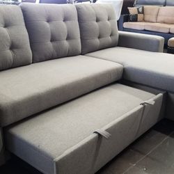 Light gray sofa chaise sectional with pullout bed