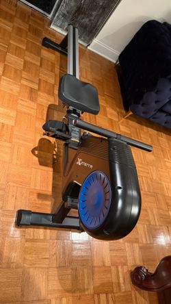 Magnetic rowing machine