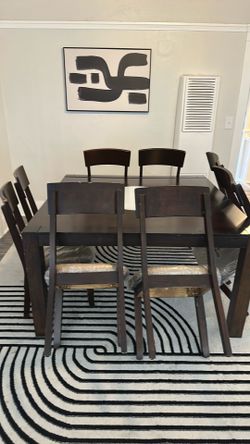Dining table with 8 chairs. Center is glass which spins