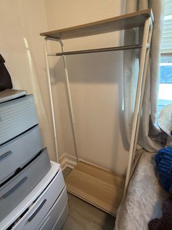 Clothing rack with hanging rods and shelf