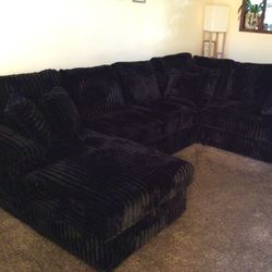 Black CURDOROY SLEEPER SECTIONAL WITH STORAGE CHAISE.  (PICTURE IS CUSTOMER.  YOU GET NEW)