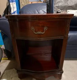 dark wood vintage nightstand with a single top drawer and an open lower shelf