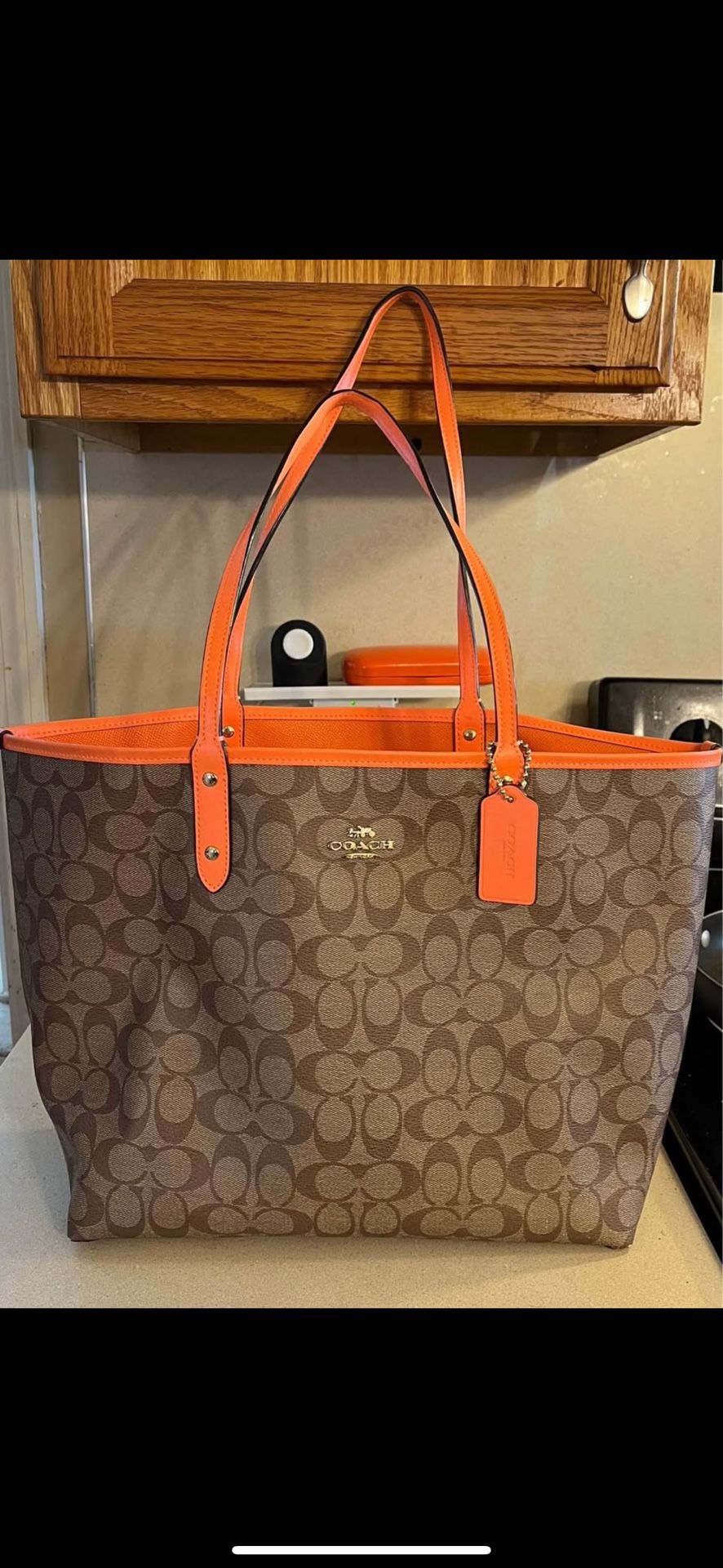 COACH reversible orange and brown logo bag